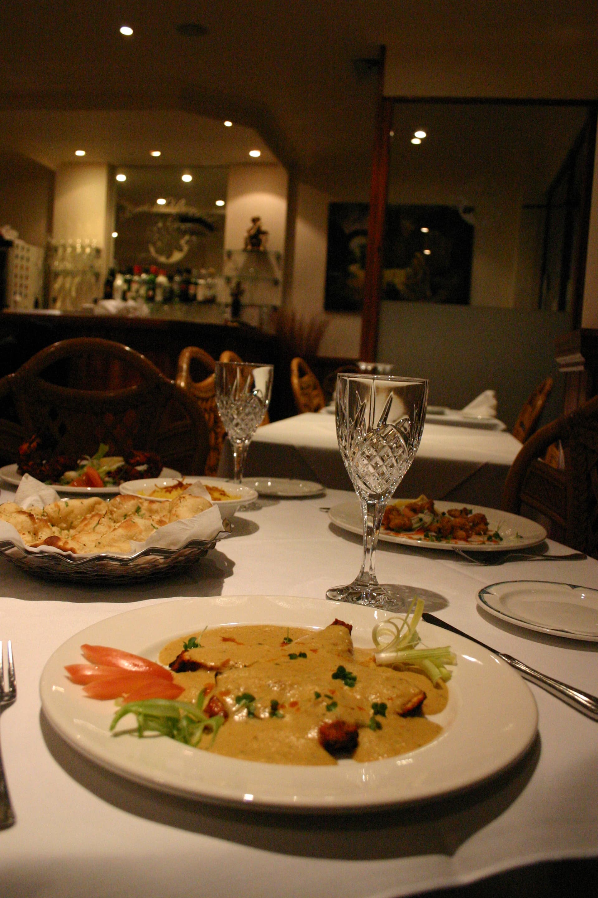 Table set for dinner with curry and nan bread