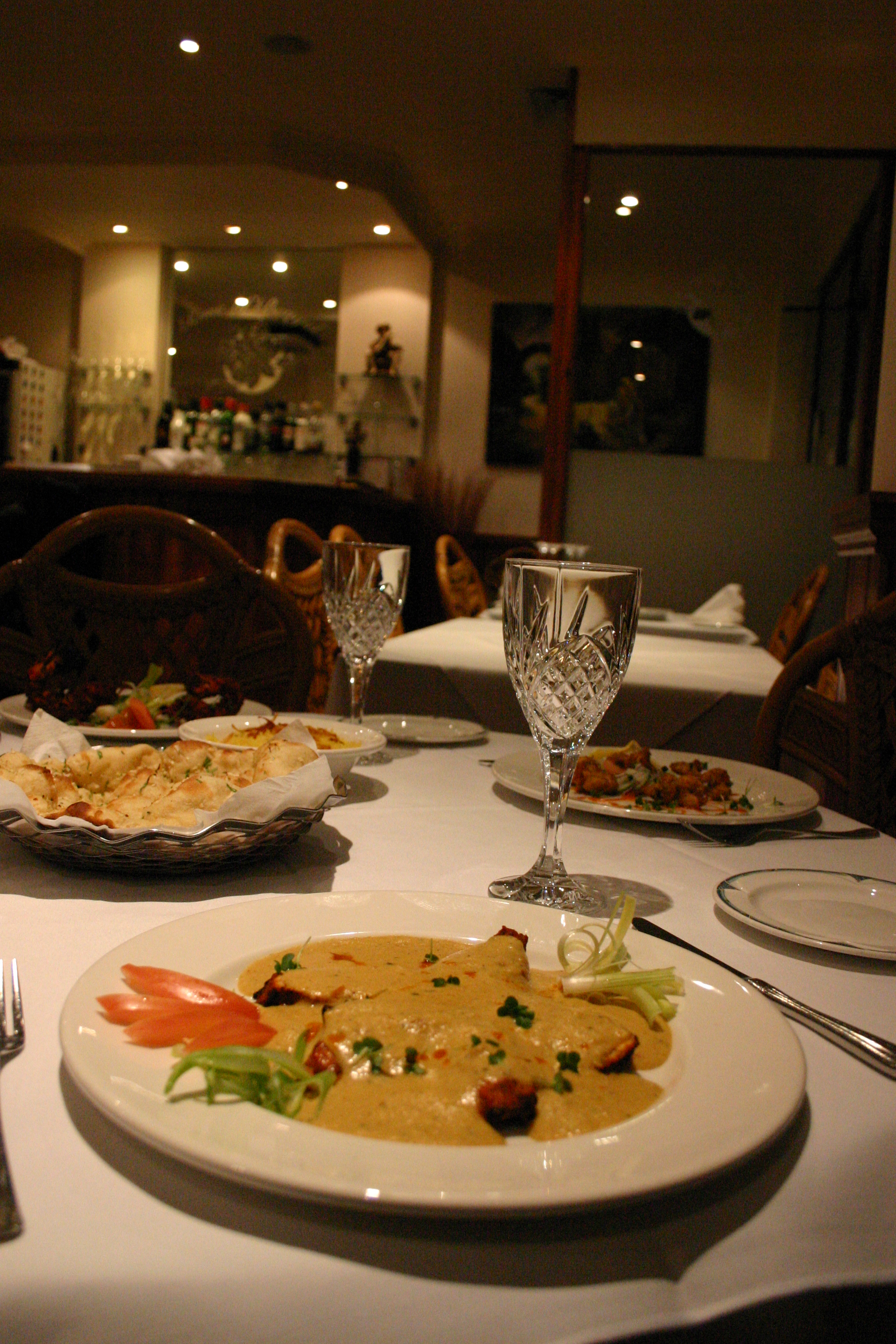 Table set for dinner with curry and nan bread